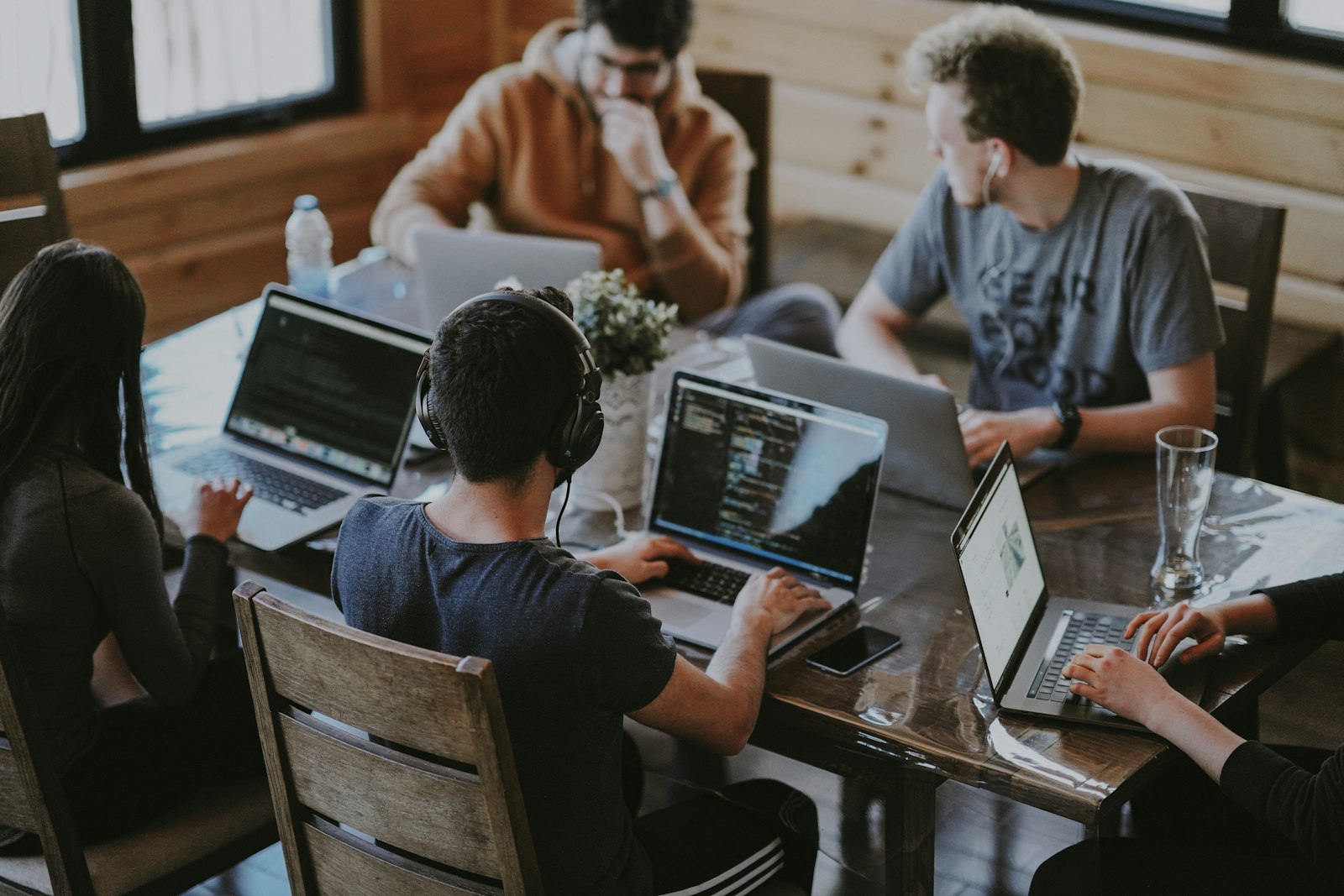 A UK advisory team discussing a business valuation article in a meeting room, representing collaborative editorial work.